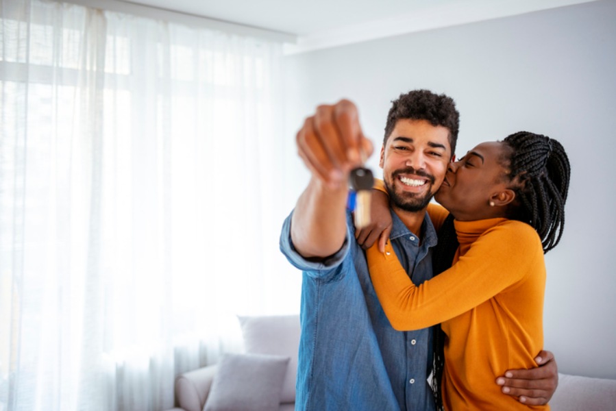Couple Holding Keys after Purchasing a New Home