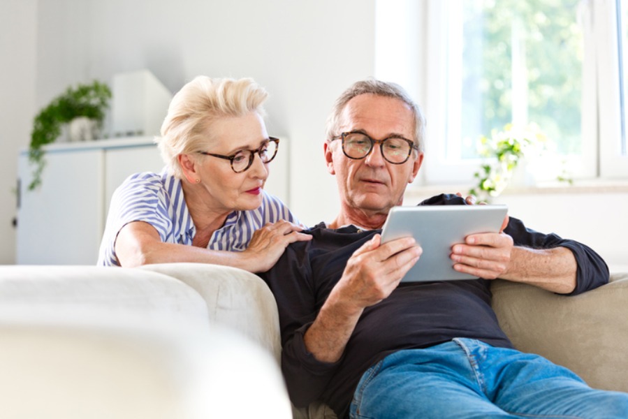 Older Couple on a Tablet discussing retirement funds